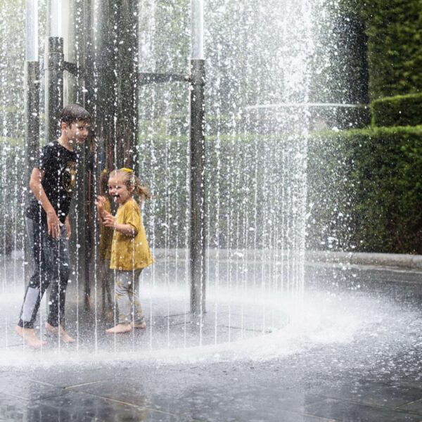 Children standing under a water feature at Alnwick Gardens